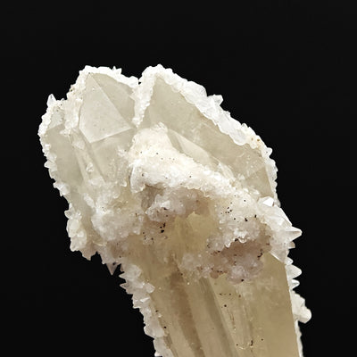 Top termination of quartz crystal with calcite overgrowth, Italy