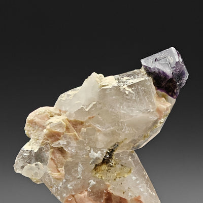 Back view of smoky quartz matrix with violet fluorite cube, Curino, Italy