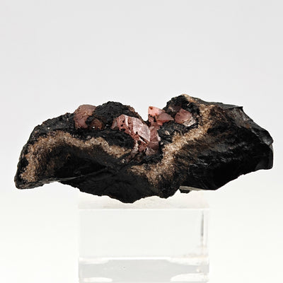 Full specimen view of rhodochrosite crystal cluster on matrix, Peru