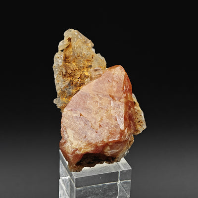 Scheelite specimen on stand showing crystal faces and quartz matrix, China