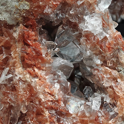 Clear Celestine crystals clustered in a vug with orange matrix, Beineu-Kyr, Turkmenistan