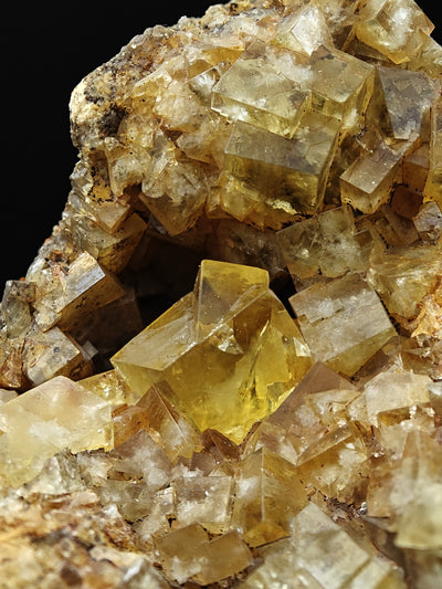 Gemmy yellow fluorite cube among smaller crystals, Hilton Mine, Cumbria