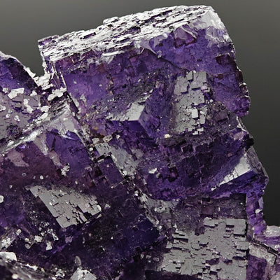 Angled detail of fluorite crystal corner with visible cubic cleavage lines