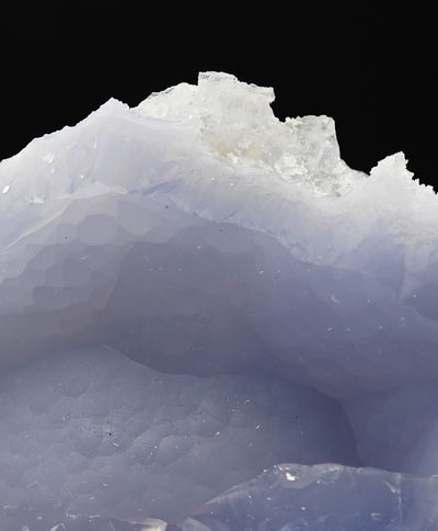 Close-up of druzy quartz crystals atop blue chalcedony from Ngabu