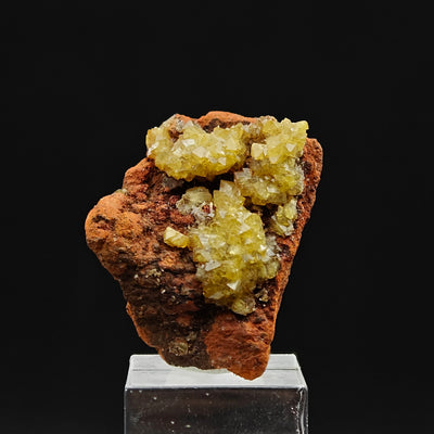 Adamite specimen on display stand showing crystal clusters on gossan matrix, Ojuela Mine, Mexico