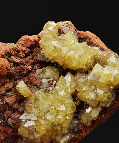 Detail view of well-formed adamite crystal clusters on reddish matrix, Ojuela Mine, Mexico