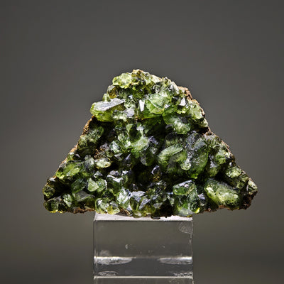 Ludlamite specimen on matrix mounted on acrylic base, studio lighting