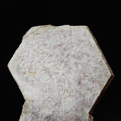 Back side of lepidolite plate showing pale cleavage surface and edge thickness