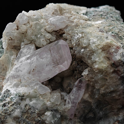 Close-up of rose-pink amethyst quartz crystal with clear quartz, Sardinia
