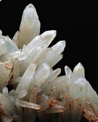 Detail of translucent prase quartz crystals with iron oxide coatings