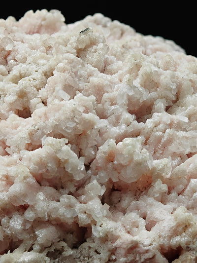 Close-up of druzy Calcite crystals over pink Rhodochrosite matrix