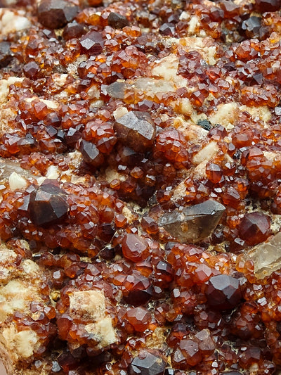 Detailed view of spessartine garnet crystals intergrown with quartz, Tongbei locality