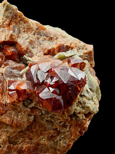 Profile view of grossular garnet crystal cluster on matrix edge