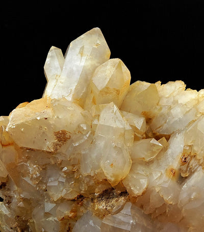 Close-up of prismatic Quartz crystal terminations showing yellow Limonite coating