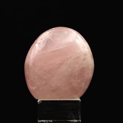 Rounded Rose Quartz tumbled stone with translucent pink hue