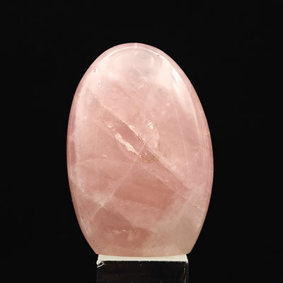 Oval Rose Quartz tumbled stone with natural internal fractures visible