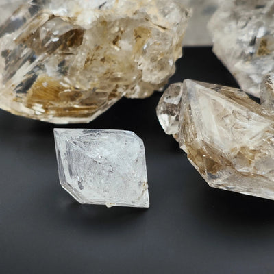 Detail of a hopper Quartz Diamond crystal beside larger specimens, Italy